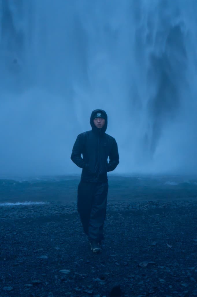 Portrait in front of a misty waterfall at blue hour