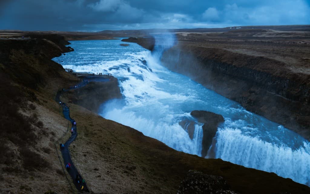 Gullfoss waterfall cascading into a canyon under stormy skies, Iceland